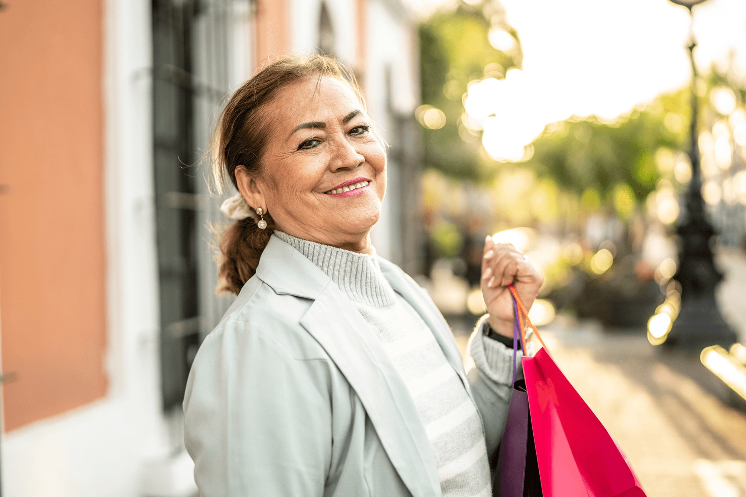 older woman holding shopping bags